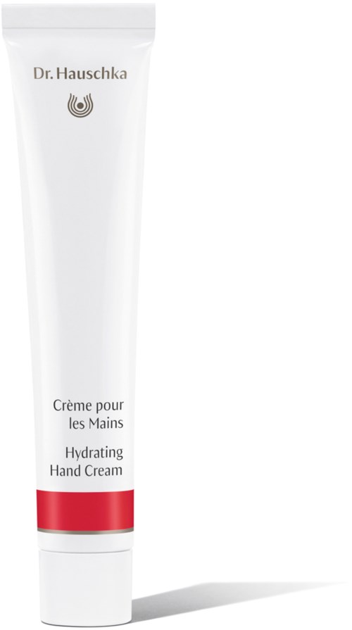 En hvit tube med håndkrem med en rød stripe, merket 'Dr. Hauschka Hydrating Hand Cream'.