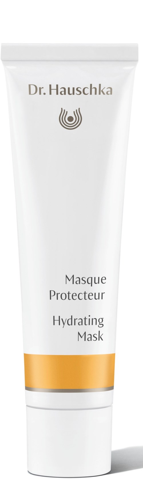 En hvit tube med gullfarget bånd, merket Dr. Hauschka Hydrating Mask, står oppreist.
