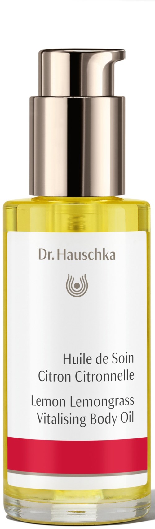 Läpinäkyvä pullo, jossa keltaista nestettä ja hopeasuihku, etiketti sitruunan vartalovoi, valmistaja Dr. Hauschka.