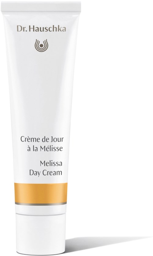 En hvit tube med gullbånd, merket Dr. Hauschka Melissa Day Cream, skrevet på fransk og engelsk.
