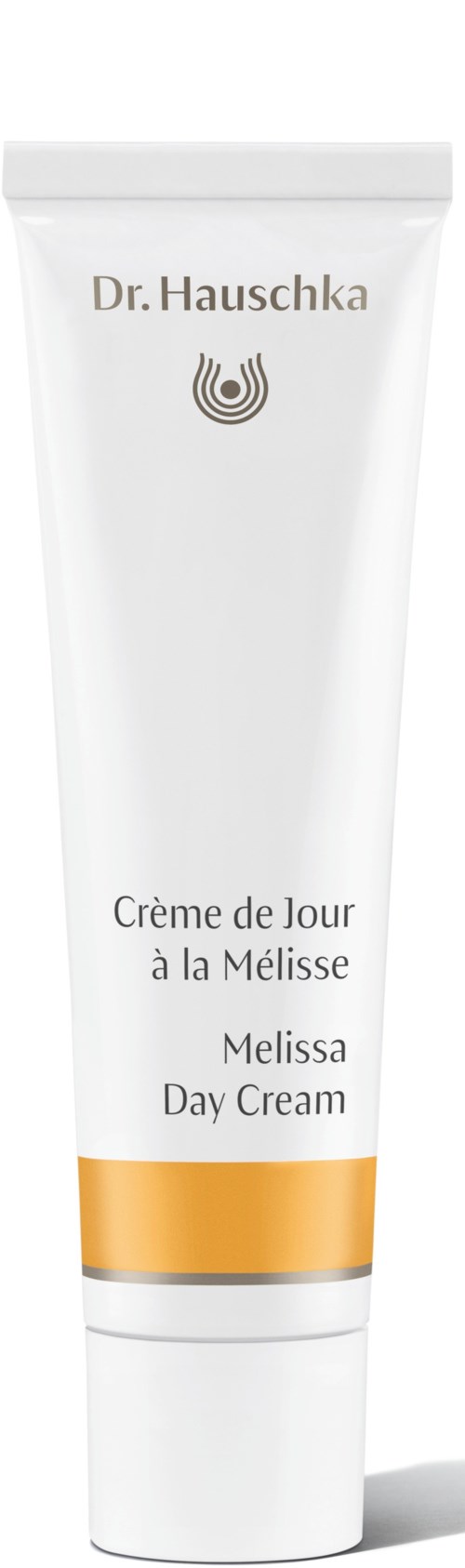 Een witte tube met Dr. Hauschka Melissa Day Cream met gouden rand, in meerdere talen gelabeld.