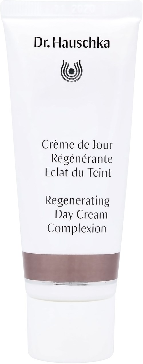 En vit tub med Dr. Hauschka regenererande dagkräm med svart text och logga, och en brun rand nära botten.