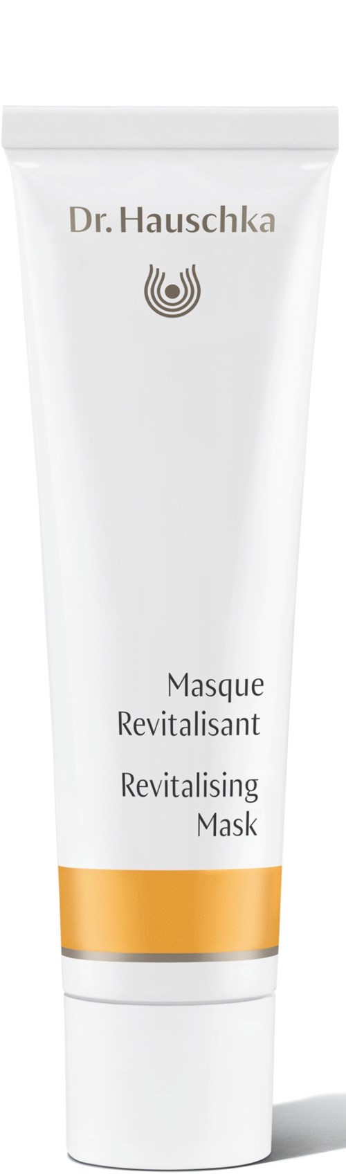 Eine weiße Tube mit goldenem Band, beschriftet Dr. Hauschka Revitalising Mask, steht aufrecht.