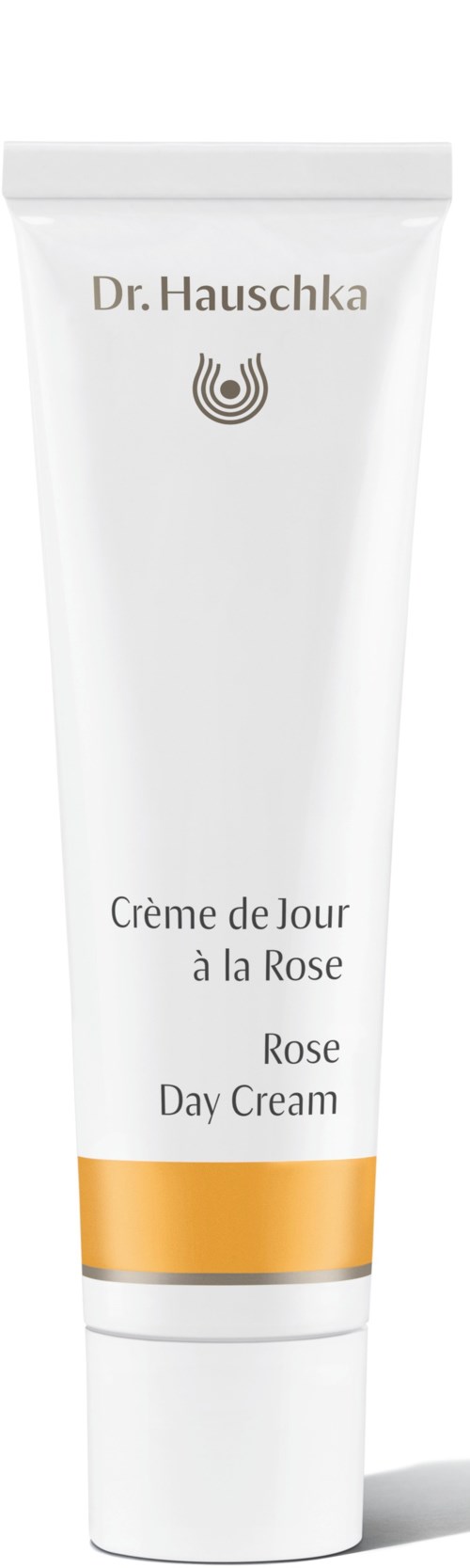 En hvit tube med rose dagkrem fra Dr. Hauschka med gull og svart detaljer.
