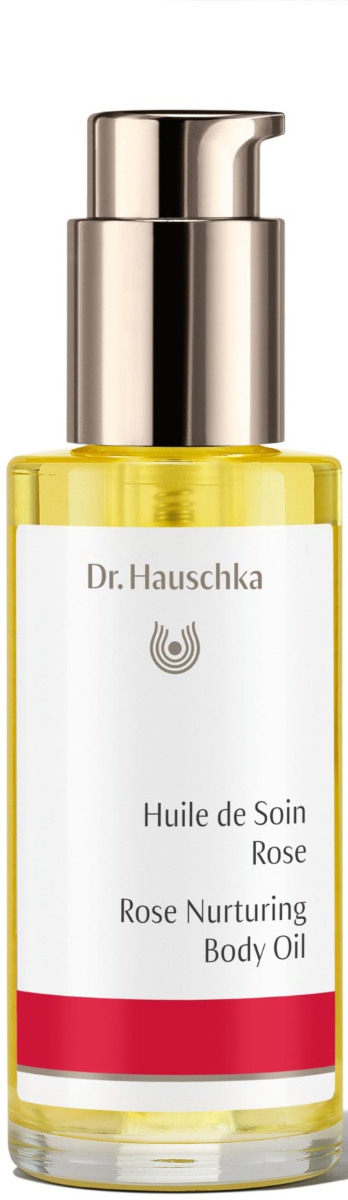 A clear bottle with a silver pump, containing yellow rose nurturing body oil by Dr. Hauschka.