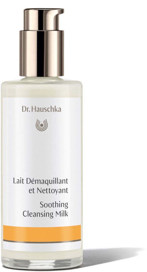 A white bottle with a silver pump, labeled 'Dr. Hauschka Soothing Cleansing Milk,' with a yellow stripe at the bottom.