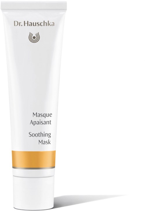 A white tube of soothing mask with gold stripe, labeled Dr. Hauschka, stands upright.