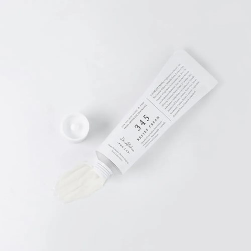 A tube labeled 'Relax' with white cream spilling out, and a small round container nearby on a white background.