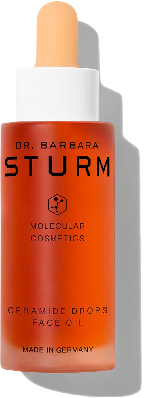 A red bottle with a dropper cap labeled 'Dr. Barbara Sturm' and 'Ceramide Drops Face Oil'. It is made in Germany.