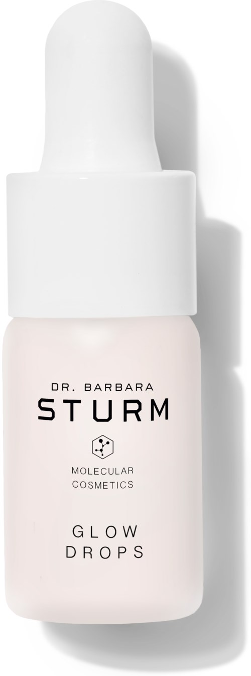 En liten vit flaska med droppock, märkt 'Dr. Barbara Sturm Glow Drops' för hudvård.
