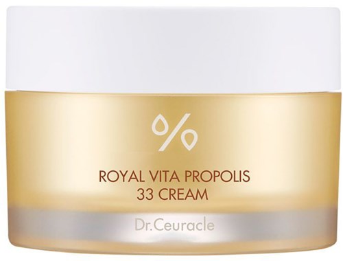 Een crèmepot met label 'Royal Vita Propolis 33 Cream' door Dr. Ceuracle. Het heeft een witte deksel en een gouden en zilveren body.