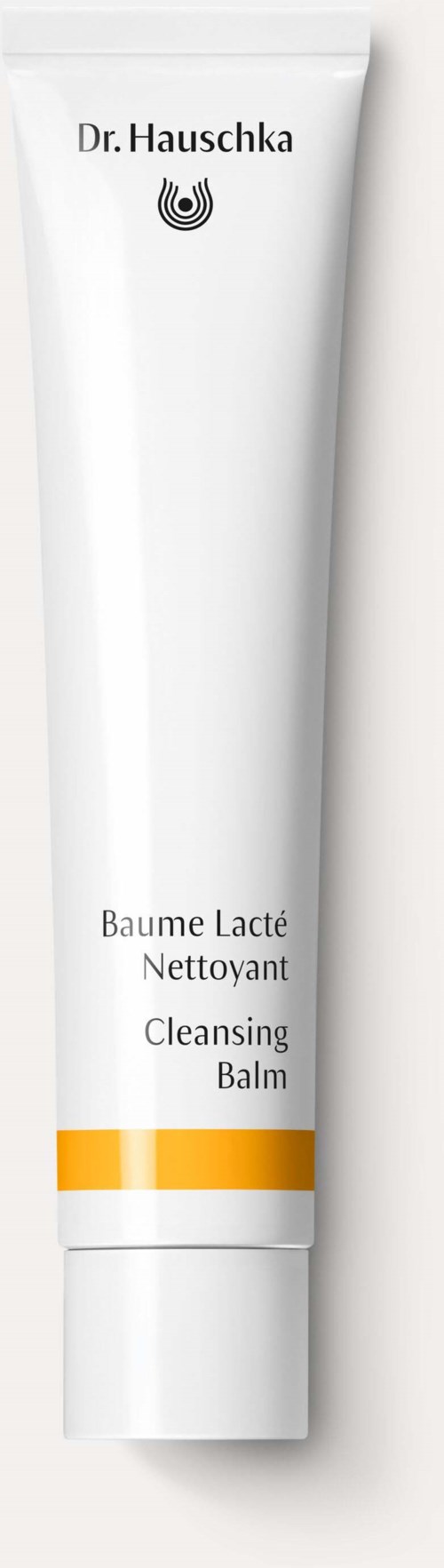 A white tube of cleansing balm with yellow and white lines, labeled 'Dr. Hauschka' and 'Cleansing Balm'.