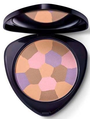 A makeup palette with pastel-colored powders in hexagonal shapes, in a round black container with a mirror.