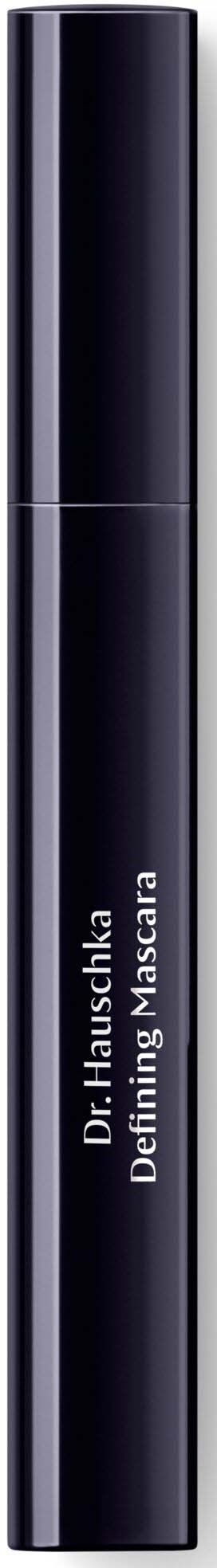 Eine elegante schwarze Tube mit der Aufschrift 'Dr. Hauschka Defining Mascara' vor dunklem Hintergrund.