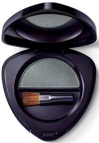 A compact makeup case with eyeshadow and a small brush inside, lid open showing the makeup surface.