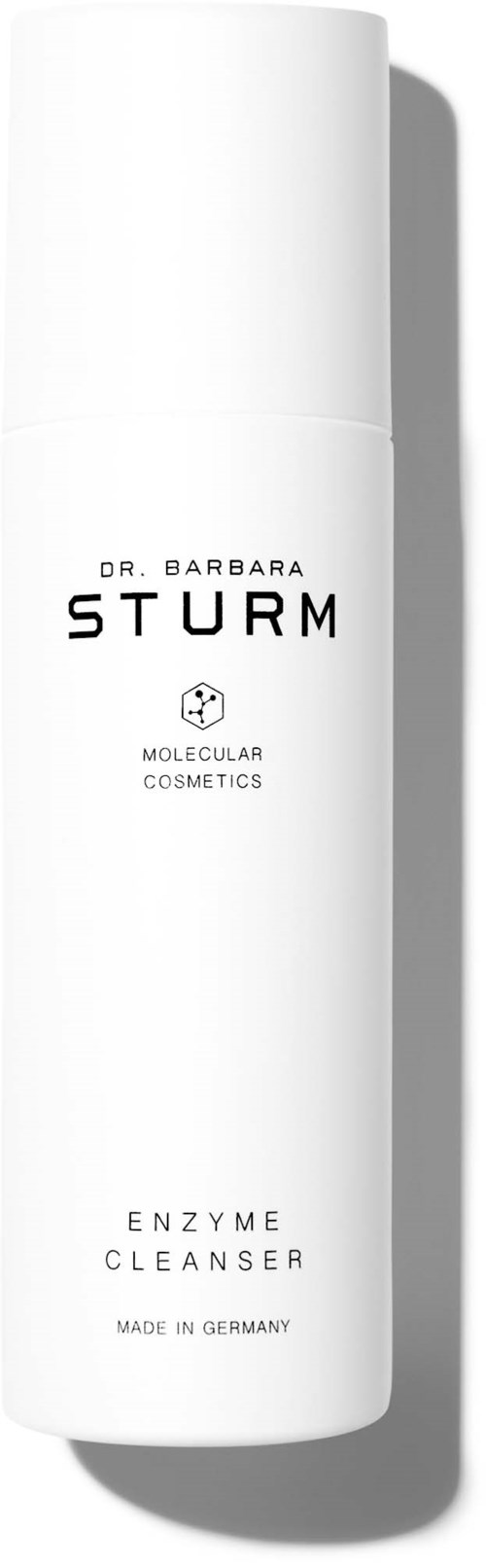 Eine weiße Flasche mit schwarzem Text: Dr. Barbara Sturm, Enzymreiniger, hergestellt in Deutschland.