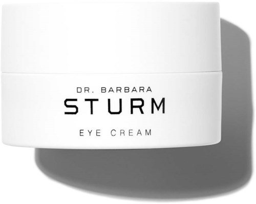 Ein weißer Behälter mit Augencreme und schwarzen Text, beschriftet 'Dr. Barbara Sturm Eye Cream,' wirft einen Schatten.