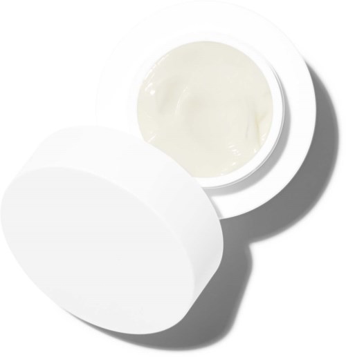 Ein Behälter mit weißer Creme, Deckel teilweise offen, zeigt die Creme.
