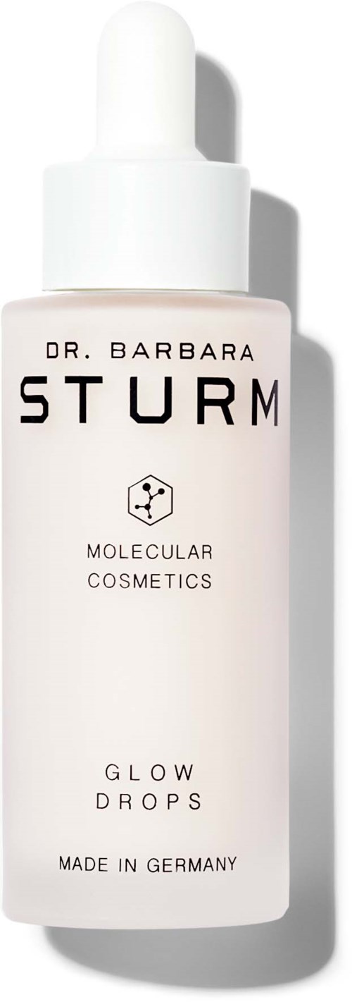 Eine weiße Flasche mit der Aufschrift 'Glow Drops' von Dr. Barbara Sturm, mit Tropfer, hergestellt in Deutschland.