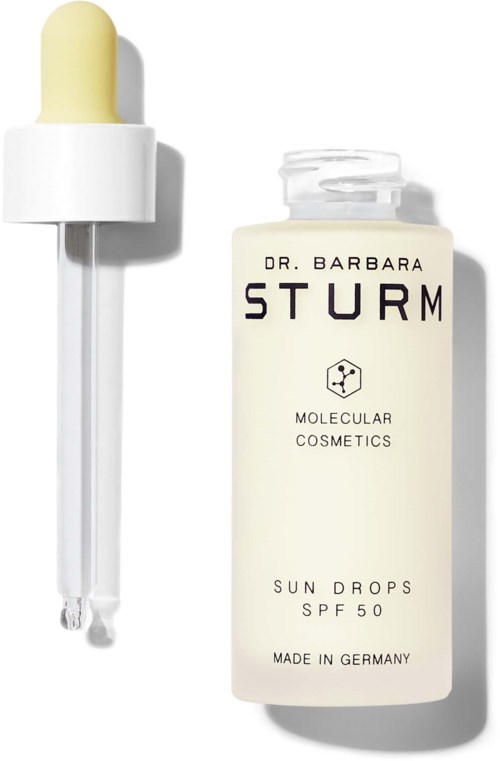 Een flesje zonnebloot met SPF 50 van Dr. Barbara Sturm, met een pipet ernaast.