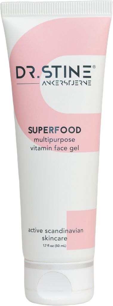 Een witte tube met roze accenten, gemerkt als Dr. Stine Superfood gezichtsgel voor gezichtsverzorging.
