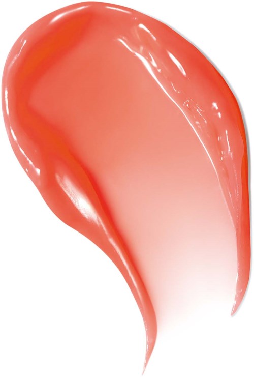 A glossy, peach-colored lip gloss on a white background.
