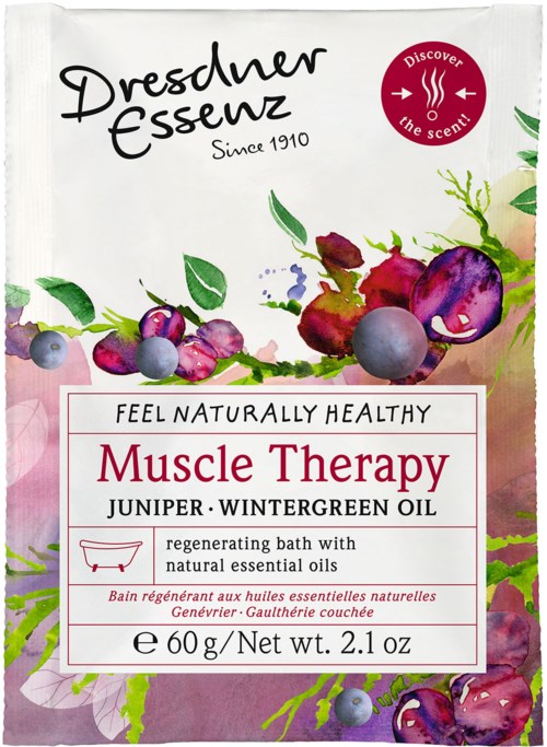 Ett vitt badtillskottspaket med färgglada bär som illustration, märkt 'Muscle Therapy' med naturliga oljor och örter.