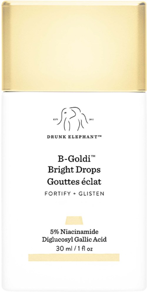 En liten hvit og gull eske med svart tekst, som viser en etikett for Drunk Elephant Bright Drops hudpleieprodukt.