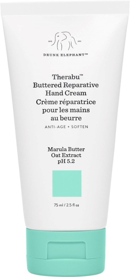 En hvit håndkremrør med blå lokk, merket som Drunk Elephant Therabu Buttered Repairative Hand Cream, 75 ml.