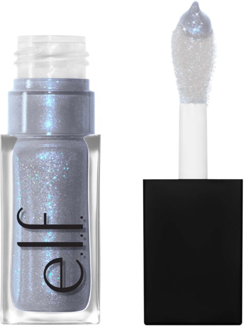 A nail polish bottle with a glittery, silver color and a black cap, with the applicator next to it.