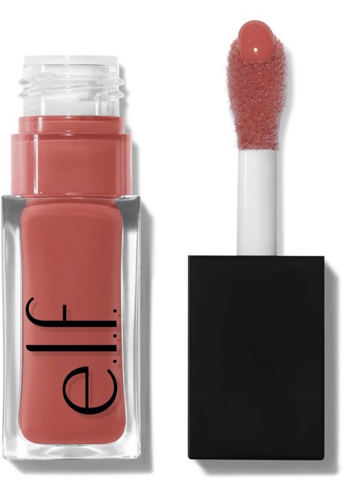 A pink liquid lipstick in a clear bottle, with a black cap and an applicator wand showing a soft pink shade.