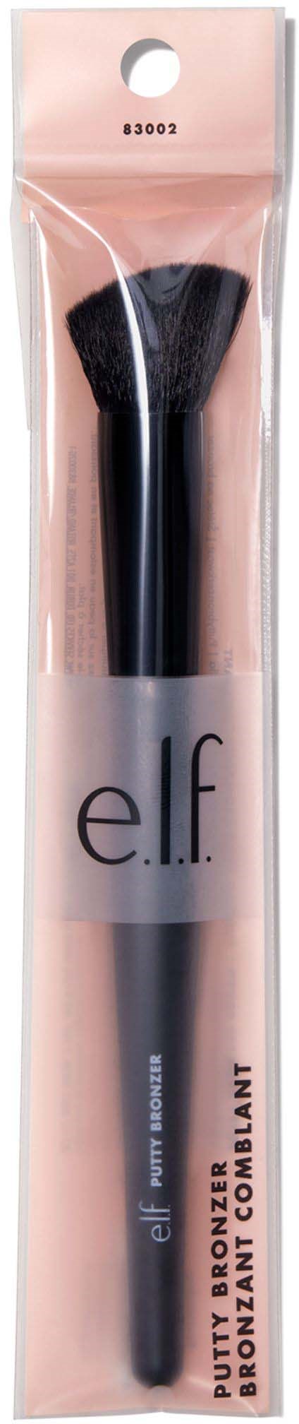 A makeup brush in pink packaging, labeled e.l.f., used for applying bronzer or blush.