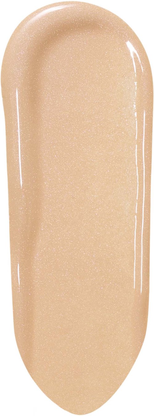 Beige ovale esine, kiiltävä ja sileä, näyttää kermalta tai meikkivoiteelta.
