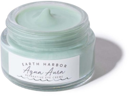 A small jar of light green eye cream from Earth Harbor, labeled 'Aqua Aura' for repair.