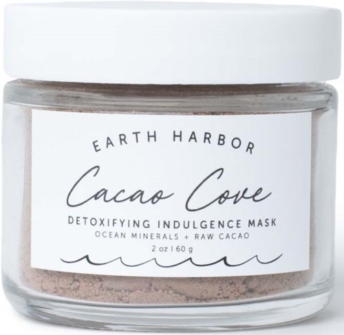 A jar of Earth Harbor Cacao Cove detoxifying mask, with ocean minerals and raw cacao, white lid, clear glass container.