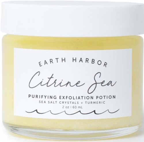 Yellow cream in a jar with a white lid, labeled 'Citrine Sea' and 'Purifying Exfoliation Potion.'