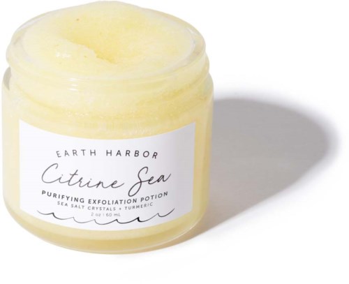 A small yellow jar with a white label reads 'Earth Harbor Citrine Sea Purifying Exfoliation Potion.'