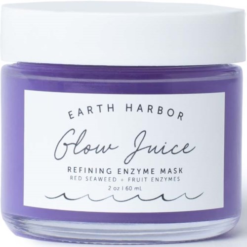 En lila burk av Earth Harbor Glow Juice med vit lock och etikett.