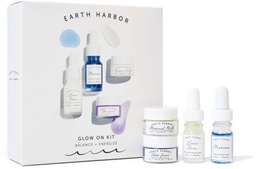 A skincare set with bottles and jars, labeled for hydration and energy, from Earth Harbor, called Glow On Kit.