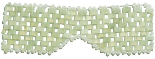 A decorative eye mask made of small beads, mostly light yellow with some white beads, shaped to cover eyes.