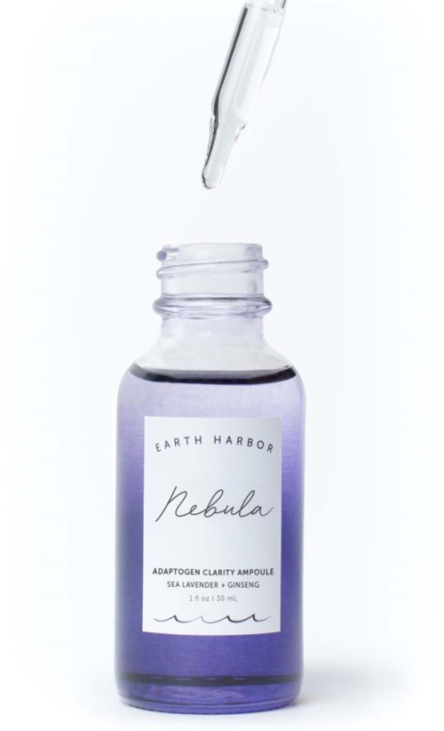 A small purple bottle with a dropper, labeled 'Rebula' from Earth Harbor, containing a serum or essence.