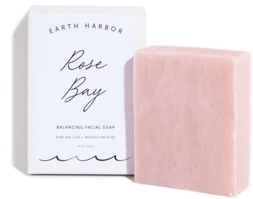 Pink soap bar next to a white box with black text, labeled Earth Harbor Rose Bay, Balancing Facial Soap.