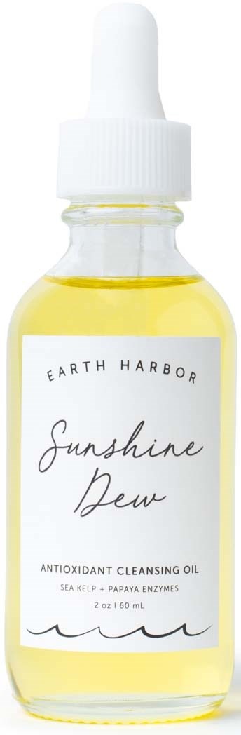 A small glass bottle with a white dropper cap contains yellow oil. Label reads 'Sunshine Dew' by Earth Harbor.