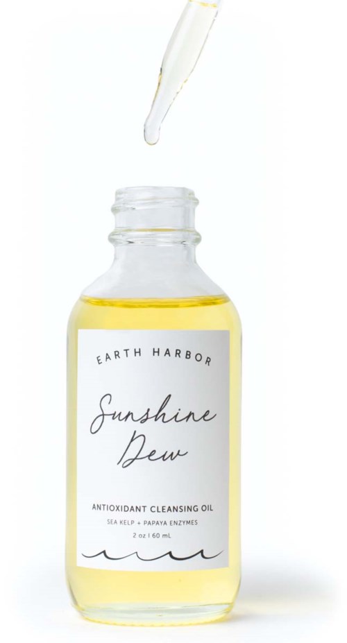A clear bottle of yellow oil labeled 'Sunshine Dew' with a dropper above, against a white background.