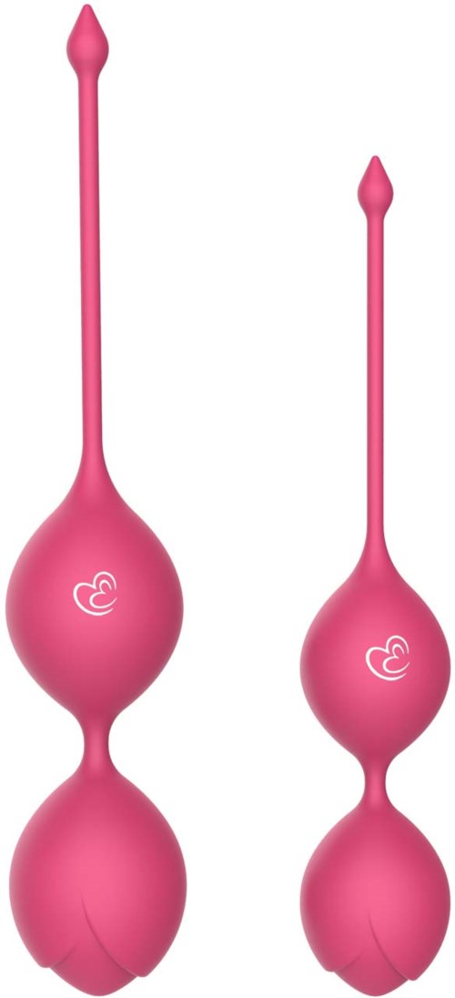 Zwei pinke vaginale Tabletten mit langen, schmalen Spitzen und runden, knollenförmigen Enden, jeweils mit kleinem Logo.
