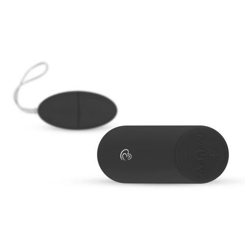 A small black device with buttons, attached to a round, black, oval-shaped remote by a string.