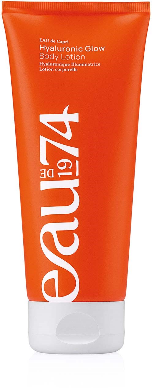 Orange tube of HydraGlow body lotion with white cap, labeled with product details. Bold white text and bright design.
