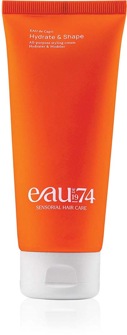 Orange tube with white cap, labeled 'eau 74', for hair care, claims to hydrate and shape hair.