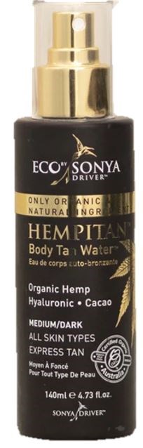 En svart flaske med gullhette og etikett, merket Eco Sonya Hemp Body Tan Water, for alle hudtyper.