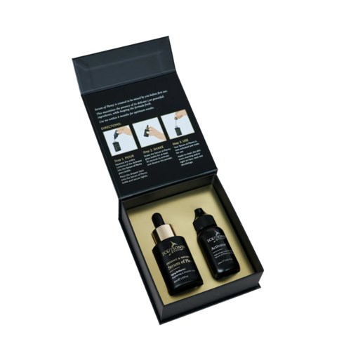 Twee flessen in een zwarte doos, waarschijnlijk huidverzorgings- of cosmetica-products, met instructies binnenin het deksel.